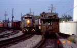 SBD 8334 leads a southbound train past the caboose on a northbound piggyback train